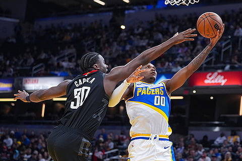 Indiana Pacers guard/forward Bennedict Mathurin (00) shoots in front of Houston Rockets center Clint Capela (30) during the first half of an NBA basketball game in Indianapolis.