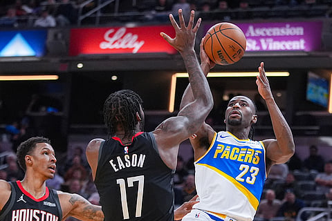Indiana Pacers guard/forward Aaron Nesmith (23) shoots over Houston Rockets forward Tari Eason (17) during the first half of an NBA basketball game in Indianapolis.