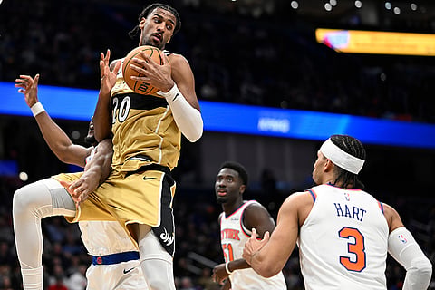 Washington Wizards center Alex Sarr grabs a rebound during the first half of an NBA basketball game against the New York Knicks in Washington.ell
