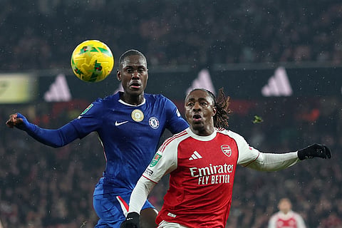 Arsenal's Eberechi Eze, right, and Chelsea's Trevoh Chalobah challenge for the ball during the English League Cup semifinal second leg soccer match between Arsenal and Chelsea in London.