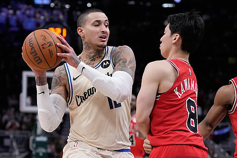 Milwaukee Bucks' Kyle Kuzma tries to get past Chicago Bulls' Yuki Kawamura during the second half of an NBA basketball game in Milwaukee.
