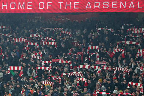 Arsenal fans support their team prior to the English League Cup semifinal second leg soccer match between Arsenal and Chelsea in London.