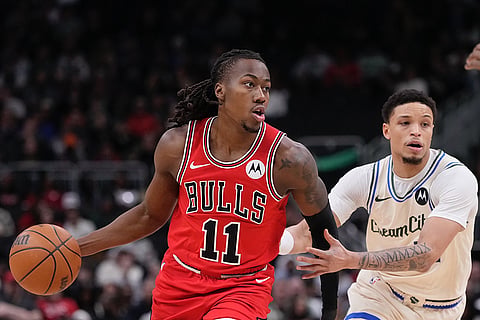 Chicago Bulls' Ayo Dosunmu gets past Milwaukee Bucks' Amir Coffey during the first half of an NBA basketball game in Milwaukee.