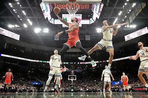 Chicago Bulls' Dalen Terry shoots past Milwaukee Bucks' Jericho Sims during the first half of an NBA basketball game in Milwaukee. 