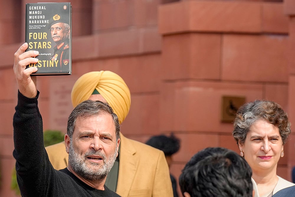 | Photo: PTI/Shahbaz Khan : Leader of Opposition in the Lok Sabha Rahul Gandhi shows a copy of the unpublished "memoir" of former Army chief M M Naravane during the Budget Session of Parliament, in New Delhi. Congress MP Priyanka Gandhi Vadra also seen. 