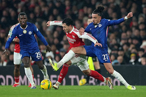 Chelsea's Malo Gusto, right, and Arsenal's Martin Zubimendi challenge for the ball during the English League Cup semifinal second leg soccer match between Arsenal and Chelsea in London.