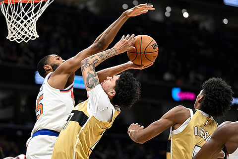 Washington Wizards guard Will Riley goes to shoot against New York Knicks guard Mikal Bridges during the first half of an NBA basketball game in Washington.