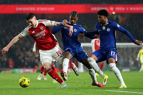 Arsenal's Viktor Gyoekeres, left, challenges for the ball with Chelsea's Jorrel Hato, center, and Chelsea's Andrey Santos during the English League Cup semifinal second leg soccer match between Arsenal and Chelsea in London.
