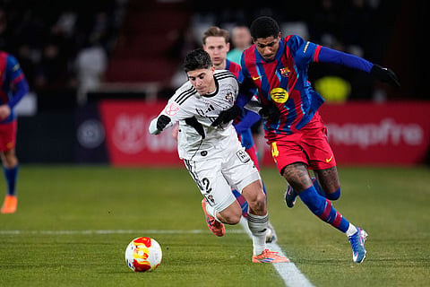 Albacete's Lorenzo Aguado fights for the ball against Barcelona's Marcus Rashford during a Copa del Rey quarterfinal soccer match between Albacete and Barcelona, in Albacete, Spain.