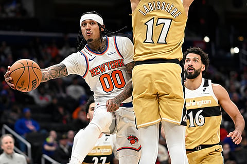 New York Knicks guard Jordan Clarkson (00) passes off around Washington Wizards center Skal Labissiere during the second half of an NBA basketball game in Washington. 