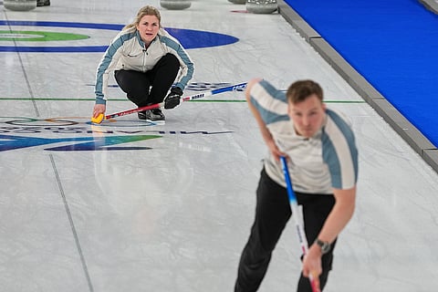 Norway's Kristin Skaslien, back, directs her teammate Magnus Nedregotten in action, during the mixed doubles round robin phase of the curling competition against Britain, at the 2026 Winter Olympics, in Cortina d'Ampezzo, Italy.