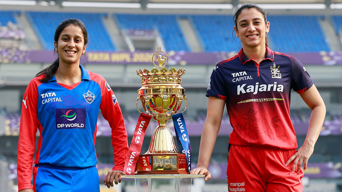 | Photo: X/wplt20 : Delhi Capitals captain Jemimah Rodrigues and Royal Challengers Bengaluru captain Smriti Mandhana with the Women's Premier League trophy.