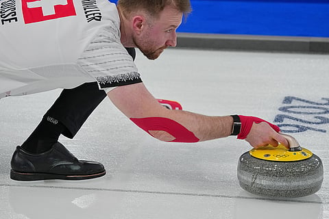 Switzerland's Yannick Schwaller in action during the mixed doubles round robin phase of the curling competition against Estonia at the 2026 Winter Olympics, in Cortina d'Ampezzo, Italy.