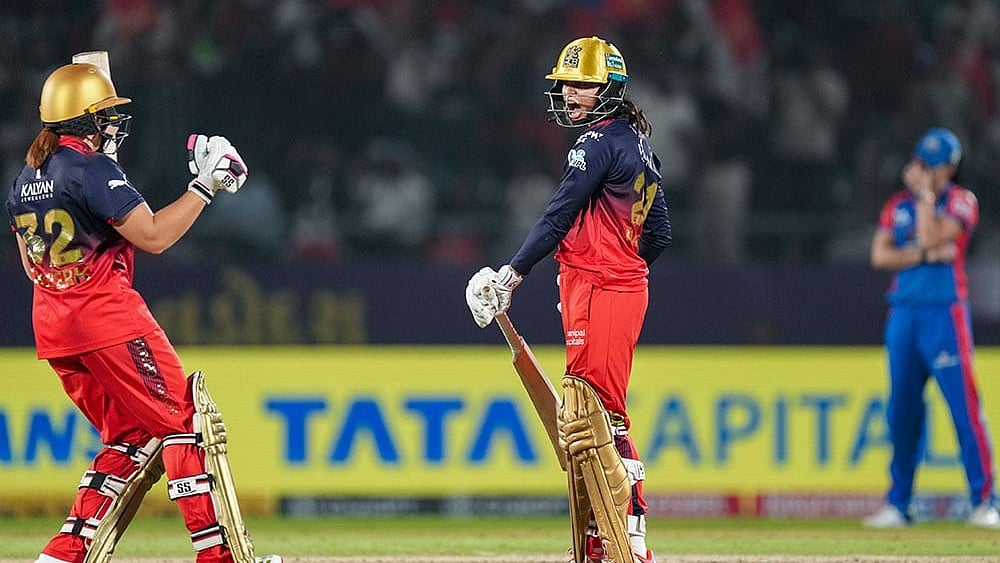Photo: PTI/Kunal Patil : RCB's Radha Yadav and Nadine de Klerk celebrate after the team won the Women's Premier League (WPL) 2026 final.