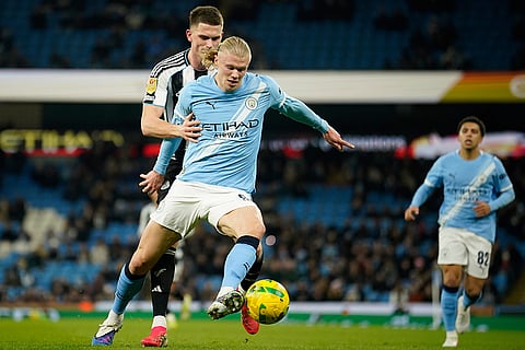 Newcastle's goalkeeper Mark Gillespie guards Manchester City's Erling Haaland during the English League Cup semifinal soccer match soccer match between Manchester City and Newcastle in Manchester, England.