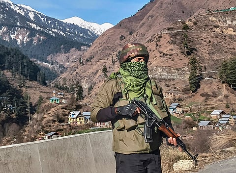 A security personnel stands guard amid intensified ground operations under Operation Trashi-I, in Kishtwar district, Jammu and Kashmir.