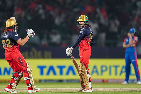 Royal Challengers Bengaluru's Radha Yadav and Nadine de Klerk celebrate after the team won the Women's Premier League (WPL) 2026 final T20 cricket match against Delhi Capitals, at Baroda Cricket Association Stadium, Kotambi in Vadodara, Gujarat.