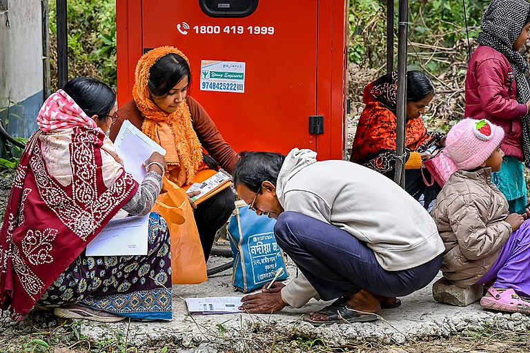 People arrange their documents during hearings under the Special Intensive Revision (SIR) of electoral rolls, in Nadia, West Bengal. - | Photo: PTI
