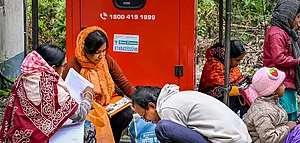 PTI : People arrange their documents during hearings under the Special Intensive Revision (SIR) of electoral rolls.