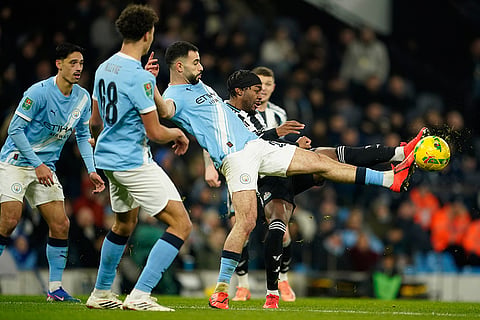 Manchester City's Rayan Ait-Nouri, left, and Newcastle's Anthony Elanga fight for the ball during the English League Cup semifinal soccer match soccer match between Manchester City and Newcastle in Manchester, England.
