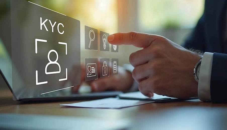 Hand interacting with digital KYC verification interface on a laptop screen