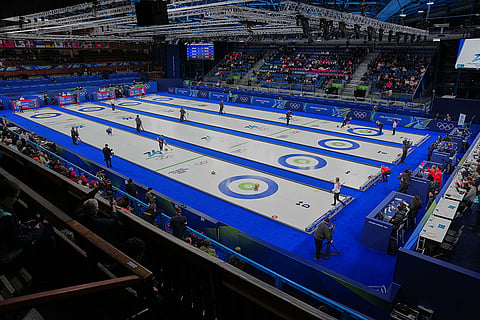 Athletes play mixed doubles curling match at the 2026 Winter Olympics, in Cortina d'Ampezzo, Italy.