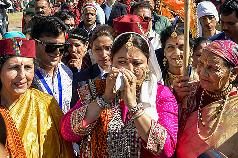 Geeta Dhami, wife of Uttarakhand CM Pushkar Singh Dhami, takes part in a religious procession on the 'Uttarayan Kauthik' festival, in Dehradun.