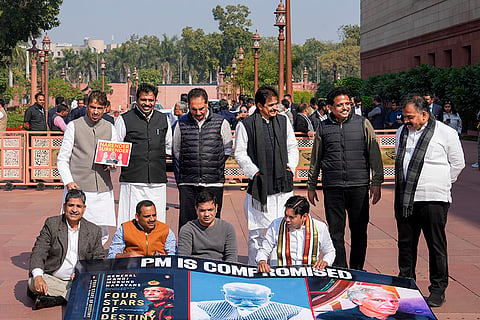 Congress MP KC Venugopal with Lok Sabha MPs who were suspended from the Lok Sabha on Tuesday for the remainder of the Budget session for "unruly behaviour'', stage a protest with a poster ‘'PM is compromised'’, at Parliament premises in New Delhi.