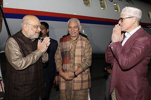 Union Home Minister Amit Shah being received by Jammu and Kashmir Lt. Governor Manoj Sinha and Chief Minister Omar Abdullah upon his arrival, in Jammu. 