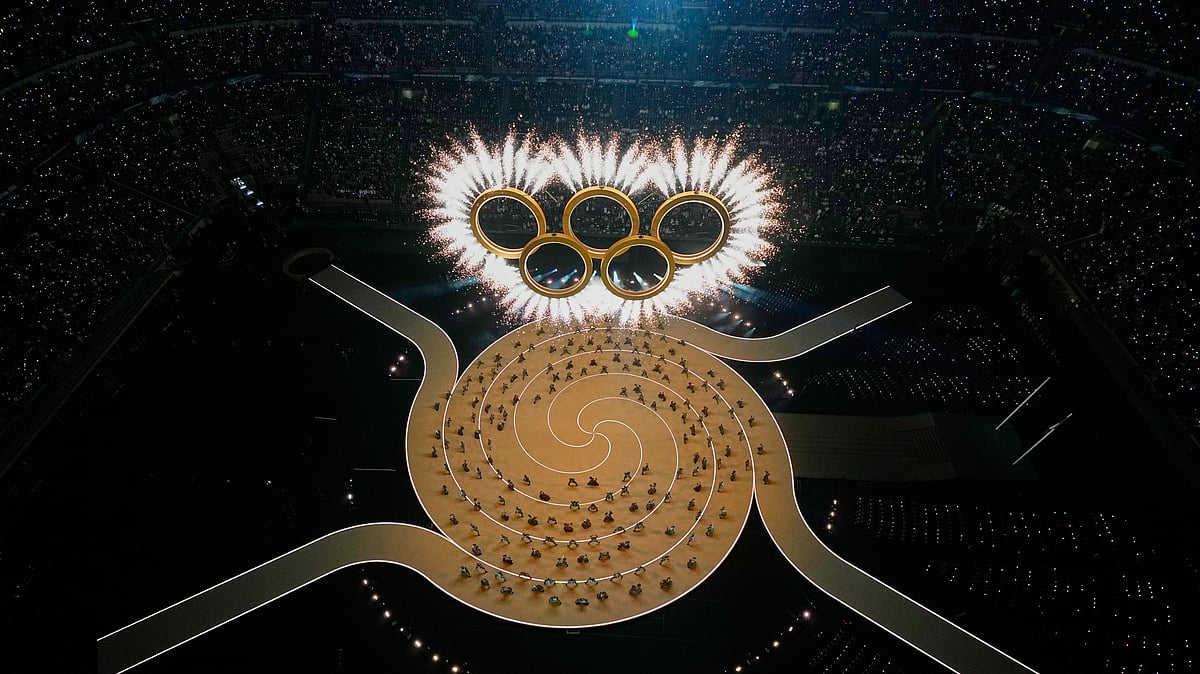 (AP Photo/David J. Phillip) : The Olympic rings are formed during the Olympic opening ceremony at the 2026 Winter Olympics, in Milan, Italy, Friday, Feb. 6, 2026. 