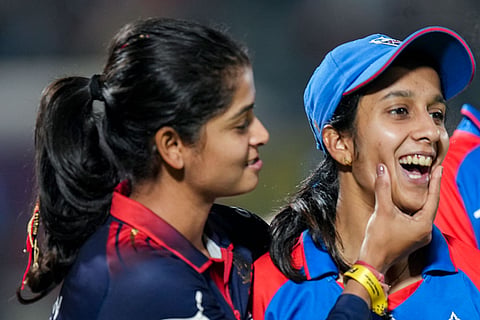 Delhi Capitals' captain Jemimah Rodrigues, in blue, with Royal Challengers Bengaluru's Shreyanka Patil, left, after the latter's team won the Women's Premier League (WPL) 2026 final T20 cricket match against Delhi Capitals, at Baroda Cricket Association Stadium, Kotambi in Vadodara, Gujarat.