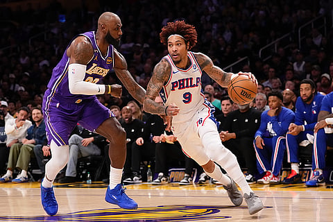 Philadelphia 76ers guard Kelly Oubre Jr., right drives by Los Angeles Lakers forward LeBron James during the first half of an NBA basketball game in Los Angeles.
