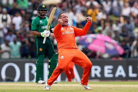 Netherlands' Roelof van der Merwe celebrates the wicket of Pakistan's Babar Azam, behind, during the T20 World Cup cricket match between Netherlands and Pakistan in Colombo, Sri Lanka.