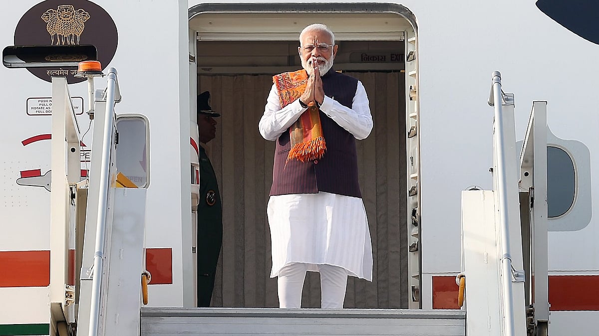 | Source: PTI : In this image released on Feb. 7, 2026, Prime Minister Narendra Modi greets as he emplanes for a two-day trip to Malaysia, in New Delhi. (PMO via PTI Photo)