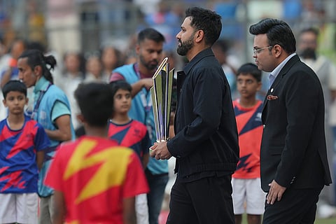 Former India captain Rohit Sharma, second right, carries ICC Men's T20 World Cup Trophy along with ICC Chairman Jay Shah, right, during the opening ceremony before the T20 World Cup cricket match between India and the United States in Mumbai.
