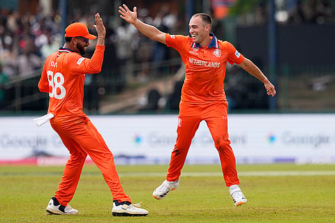 Netherlands' Kyle Klein, right, and teammate Aryan Dutt celebrate the wicket of Pakistan's Mohammad Nawaz during the T20 World Cup cricket match between Netherlands and Pakistan in Colombo, Sri Lanka.