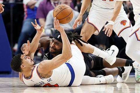 New York Knicks guard Kevin McCullar Jr. (9) passes the ball after getting control of it against Detroit Pistons forward Isaiah Stewart (28) during the first half of an NBA basketball game in Detroit.