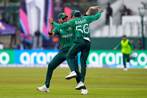 Pakistan's Babar Azam, right, and teammate Shaheen Shah Afridi celebrate after taking a co-ordinated catch to dismiss Netherlands' Michael Levitt during the T20 World Cup cricket match between Netherlands and Pakistan in Colombo, Sri Lanka.