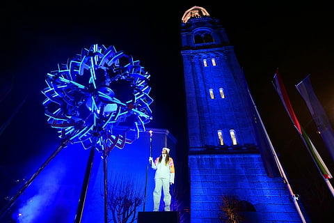 Final torchbearer Italian skier Sofia Goggia holds the torch of the Olympic flame to light the Olympic cauldron designed by Marco Balich during the Olympic opening ceremony at the 2026 Winter Olympics, in in Cortina d'Ampezzo, Italy.