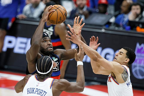 Detroit Pistons forward Isaiah Stewart, top left, goes to the basket against New York Knicks center Ariel Hukporti, bottom left, and guard Kevin McCullar Jr., right, during the second half of an NBA basketball game in Detroit.