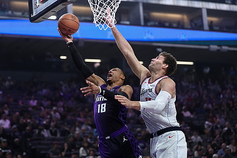 Sacramento Kings guard Russell Westbrook (18) draws the foul on Los Angeles Clippers center Brook Lopez, right, during the first half of an NBA basketball game in Sacramento, California. 