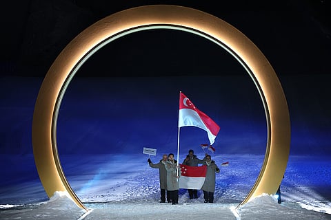 Flag bearer Faiz Basha Munwar Basha of Singapore leads the team, during the Olympic opening ceremony, at the 2026 Winter Olympics, in Livigno, Italy.