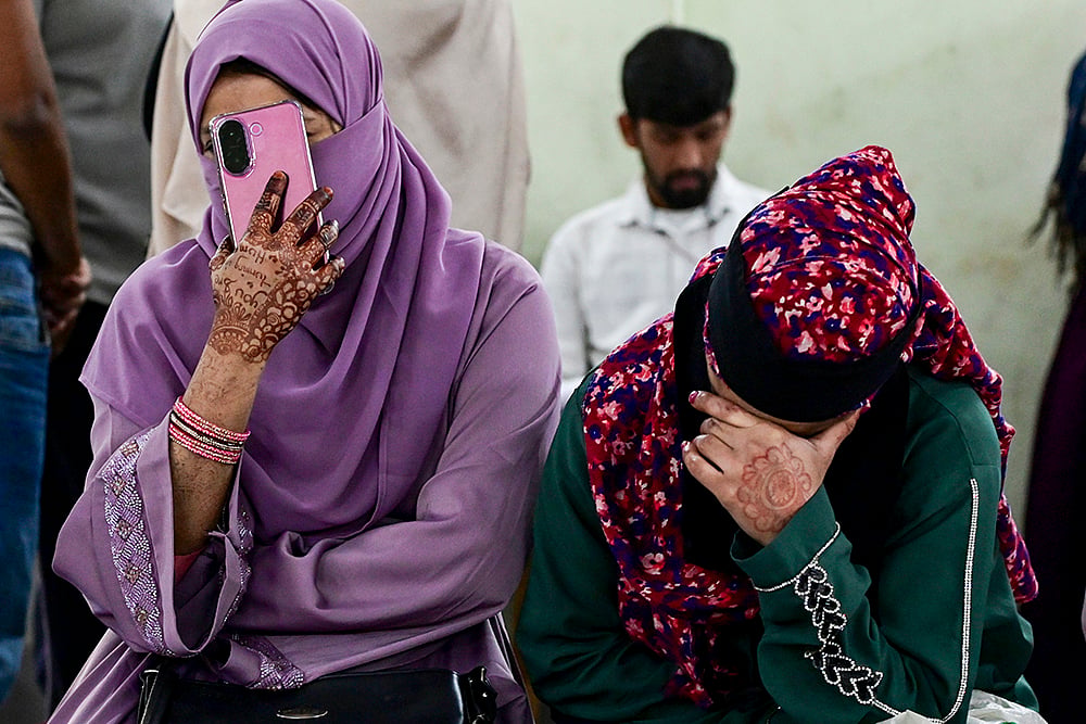 | Photo: PTI : People wait during hearings under the Special Intensive Revision of electoral rolls, at a centre, in Kolkata.