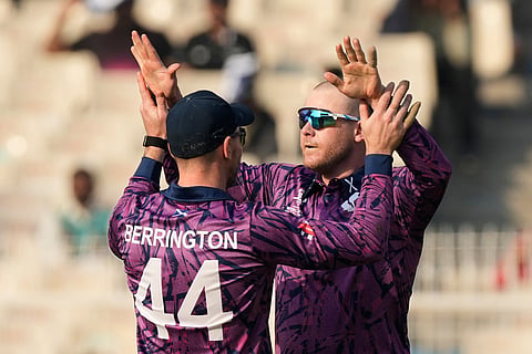 Scotland's Michael Leask, right celebrates with captain Richie Berrington the wicket of West Indies' captain Shai Hope during the T20 World Cup cricket match between Scotland and West Indies in Kolkata.