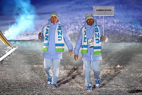 Athletes from Uzbekistan walk during the Olympic opening ceremony at the 2026 Winter Olympics, in Livigno, Italy.