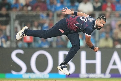 United States' Ali Khan bowls a delivery during the T20 World Cup cricket match between India and the United States in Mumbai.