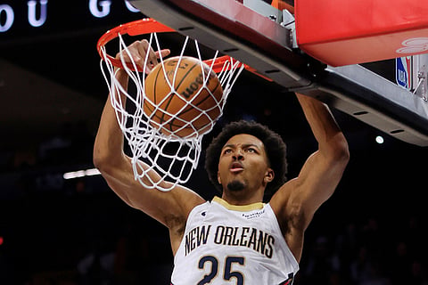 New Orleans Pelicans forward Trey Murphy III dunks against the Minnesota Timberwolves in the third quarter of an NBA basketball game in Minneapolis. 