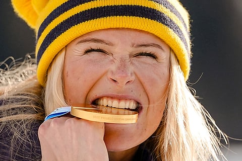 Frida Karlsson of Sweden poses with her gold medal after the cross country skiing women's 10km + 10km skiathlon at the 2026 Winter Olympics, in Tesero, Italy.