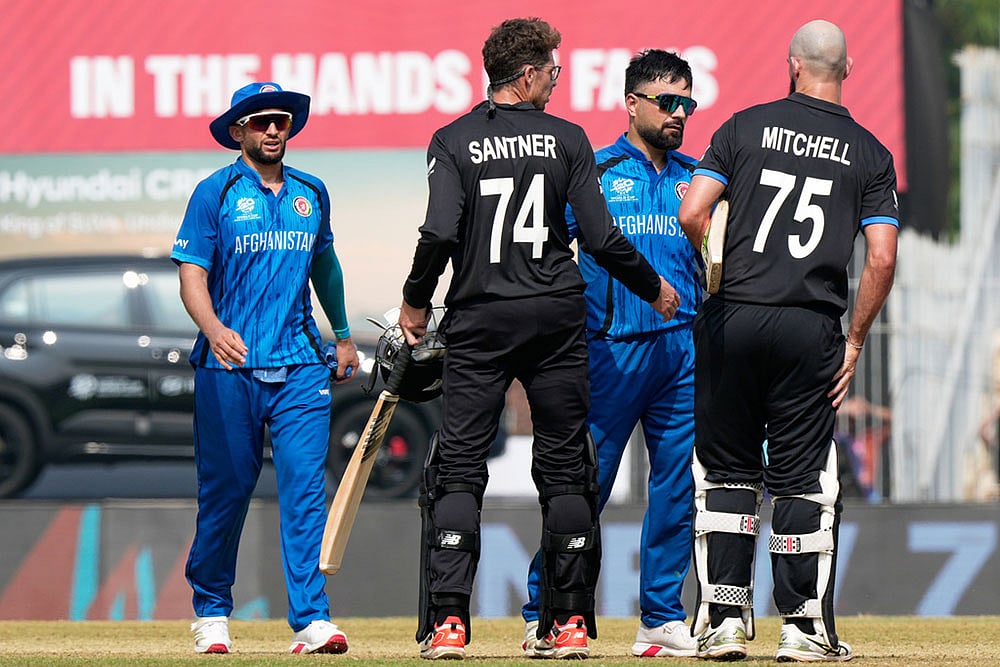 | Photo: AP/Mahesh Kumar A. : Afghanistan's captain Rashid Khan, center, greets New Zealand's Daryl Mitchell, right, and Mitchel Santner after New Zealand won their T20 World Cup cricket match against Afghanistan in Chennai, India.