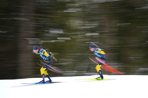 Athletes from Sweden participate in a biathlon training session at the 2026 Winter Olympics in Anterselva, Italy.